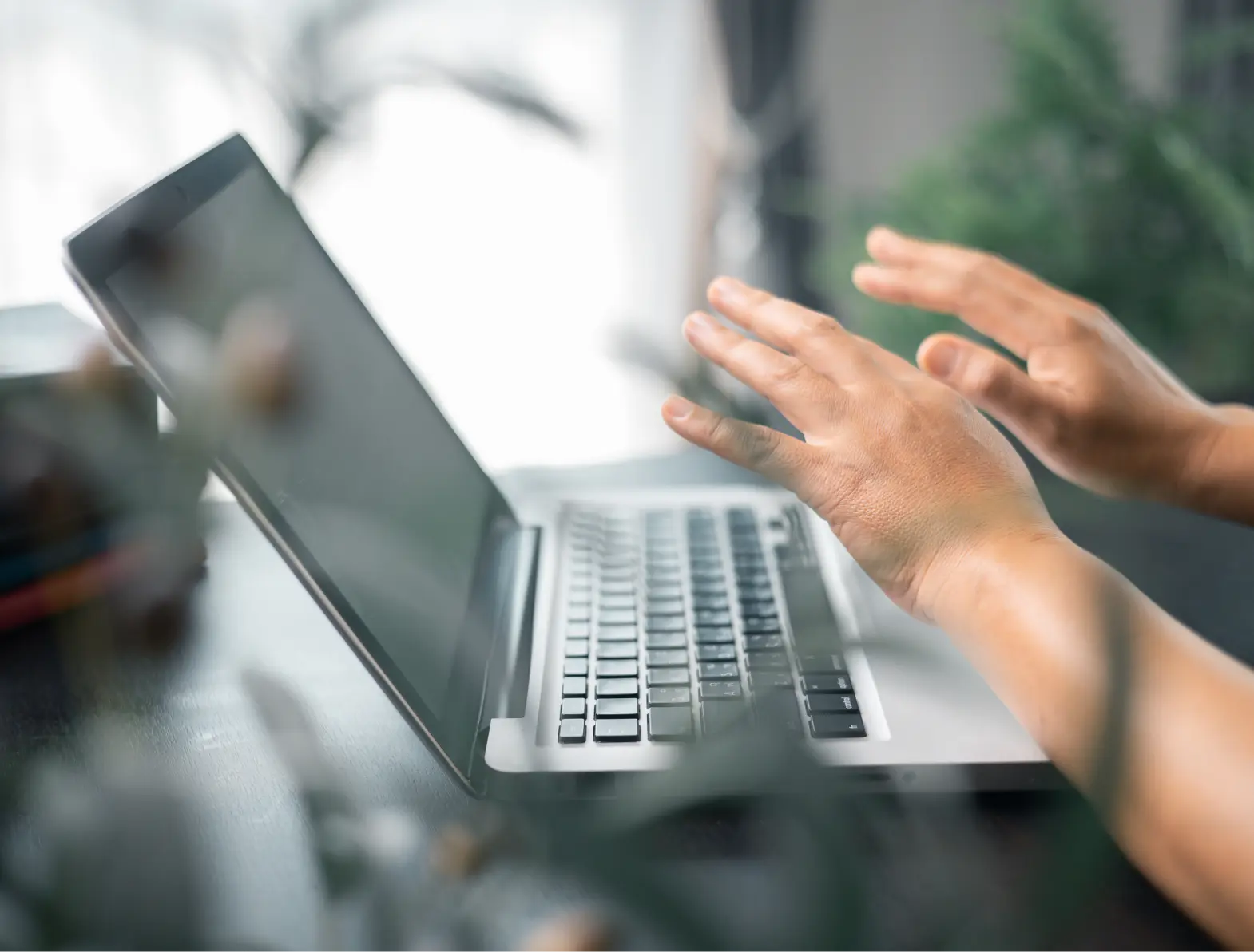 Closeup of hands near a laptop